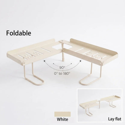 Foldable over-faucet shelf organizer in matte black and cream, folding 0 to 180 degrees over a bathroom sink